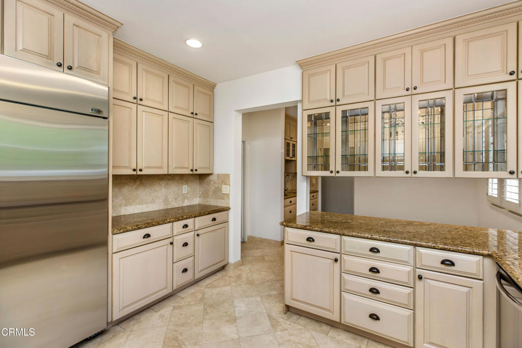 1184 Arden Road Pasadena, CA 91106 - Photo 9 of 62 a kitchen with granite countertop white cabinets and white appliances
