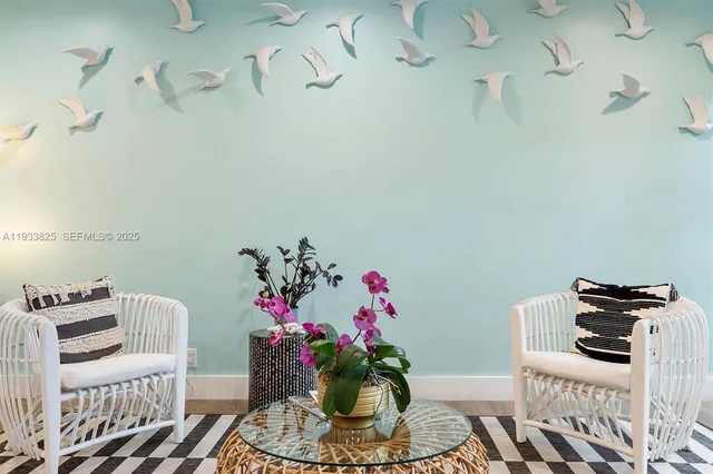 a living room with furniture a flat screen tv and kitchen view