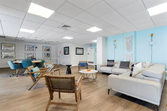 a view of a work space with furniture window and wooden floor
