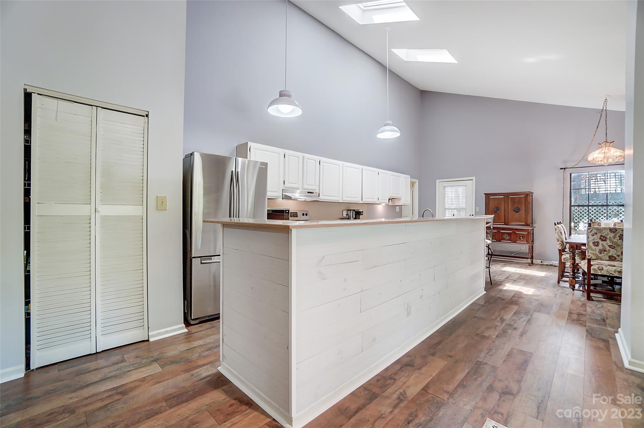 1205 Molokai Drive Tega Cay, SC 29708 - Photo 11 of 32 a kitchen with stainless steel appliances a refrigerator and wooden floor