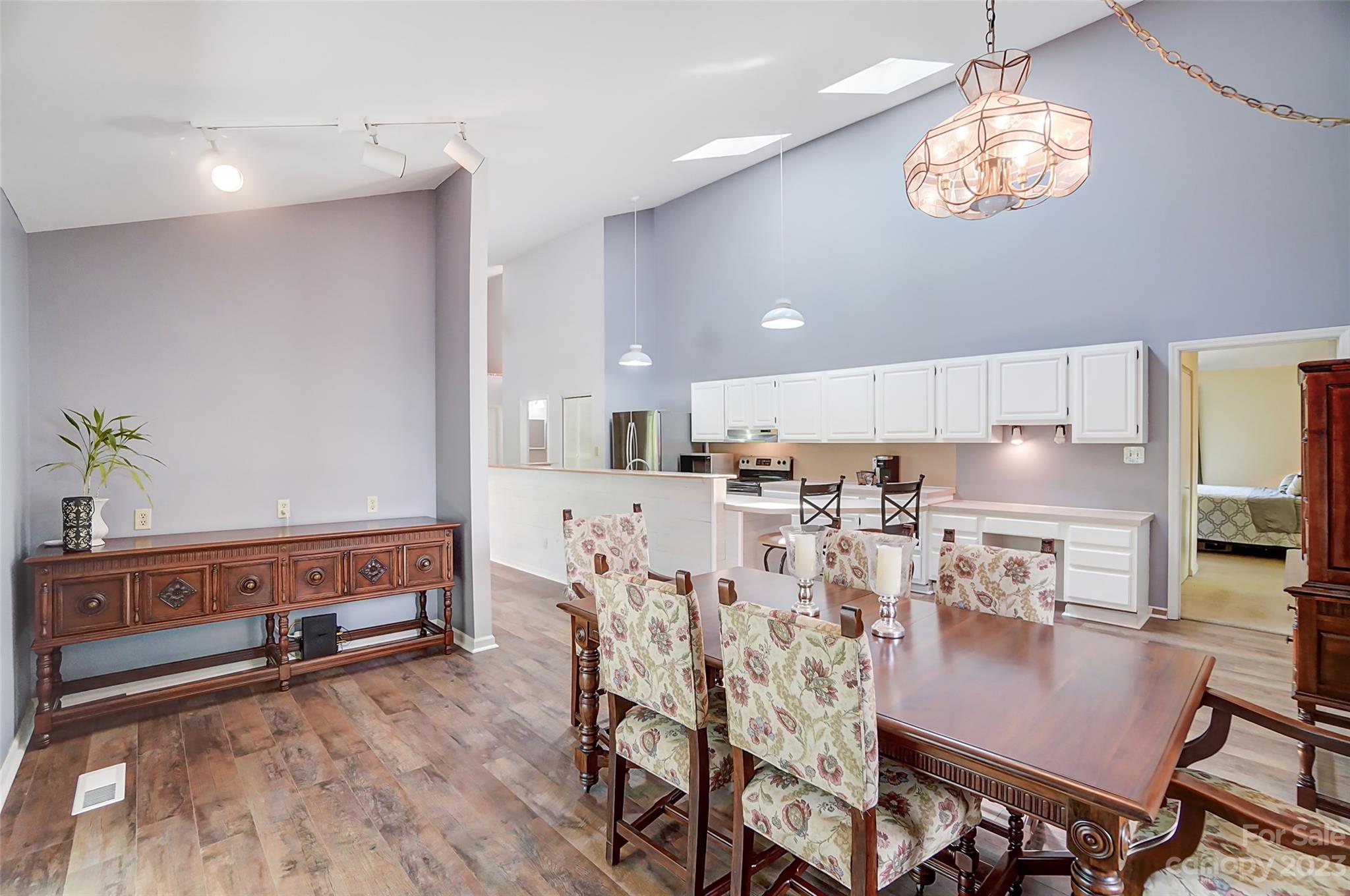 1205 Molokai Drive Tega Cay, SC 29708 - Photo 17 of 32 a view of a dining room with furniture a kitchen and chandelier