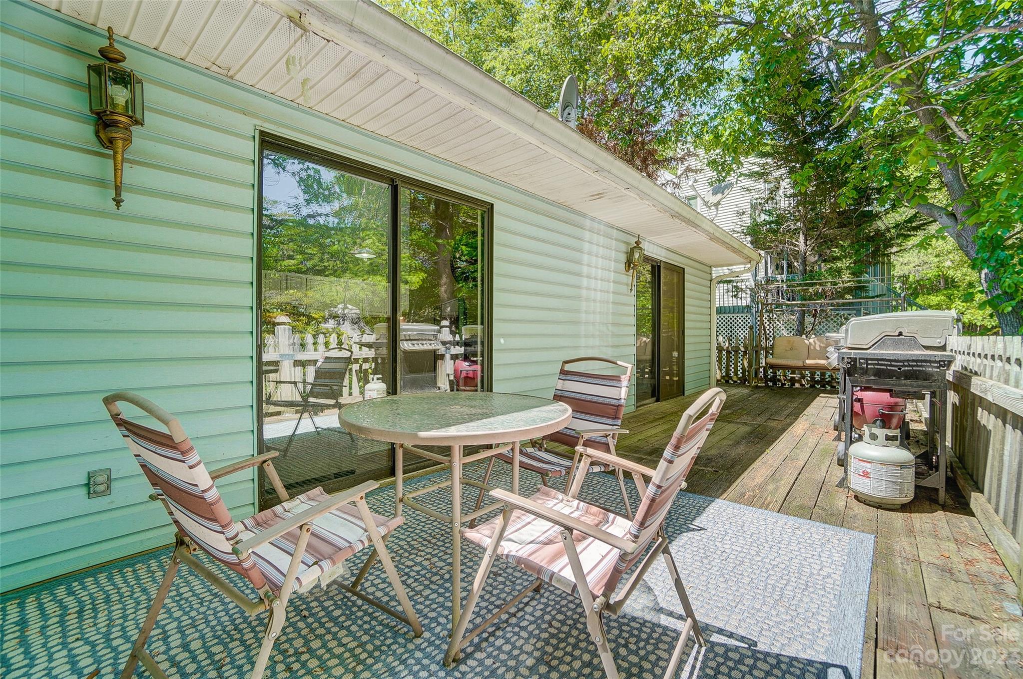 1205 Molokai Drive Tega Cay, SC 29708 - Photo 30 of 32 a view of a patio with table and chairs and potted plants