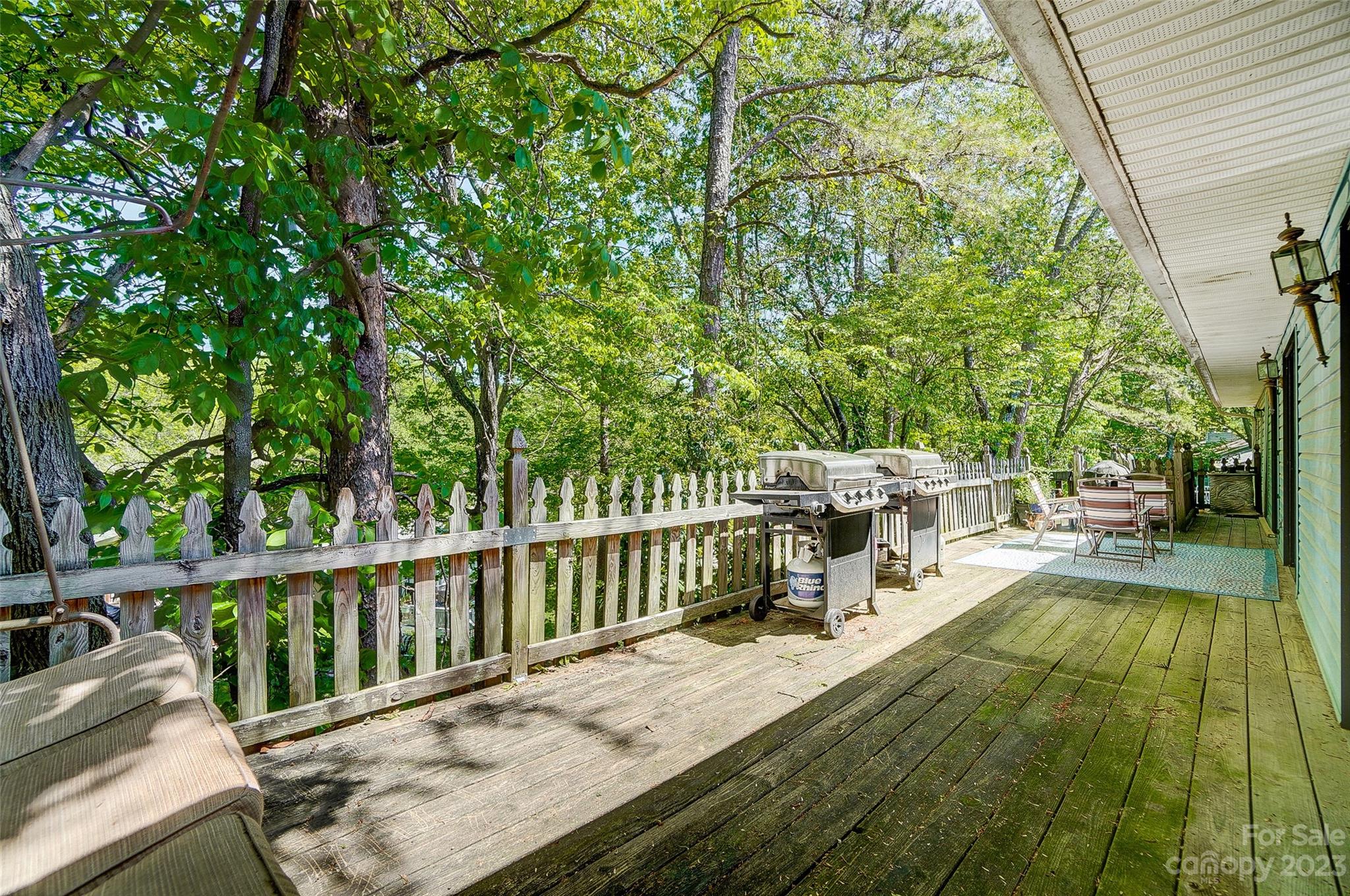 1205 Molokai Drive Tega Cay, SC 29708 - Photo 31 of 32 a view of a deck with chairs a barbeque grill with wooden fence