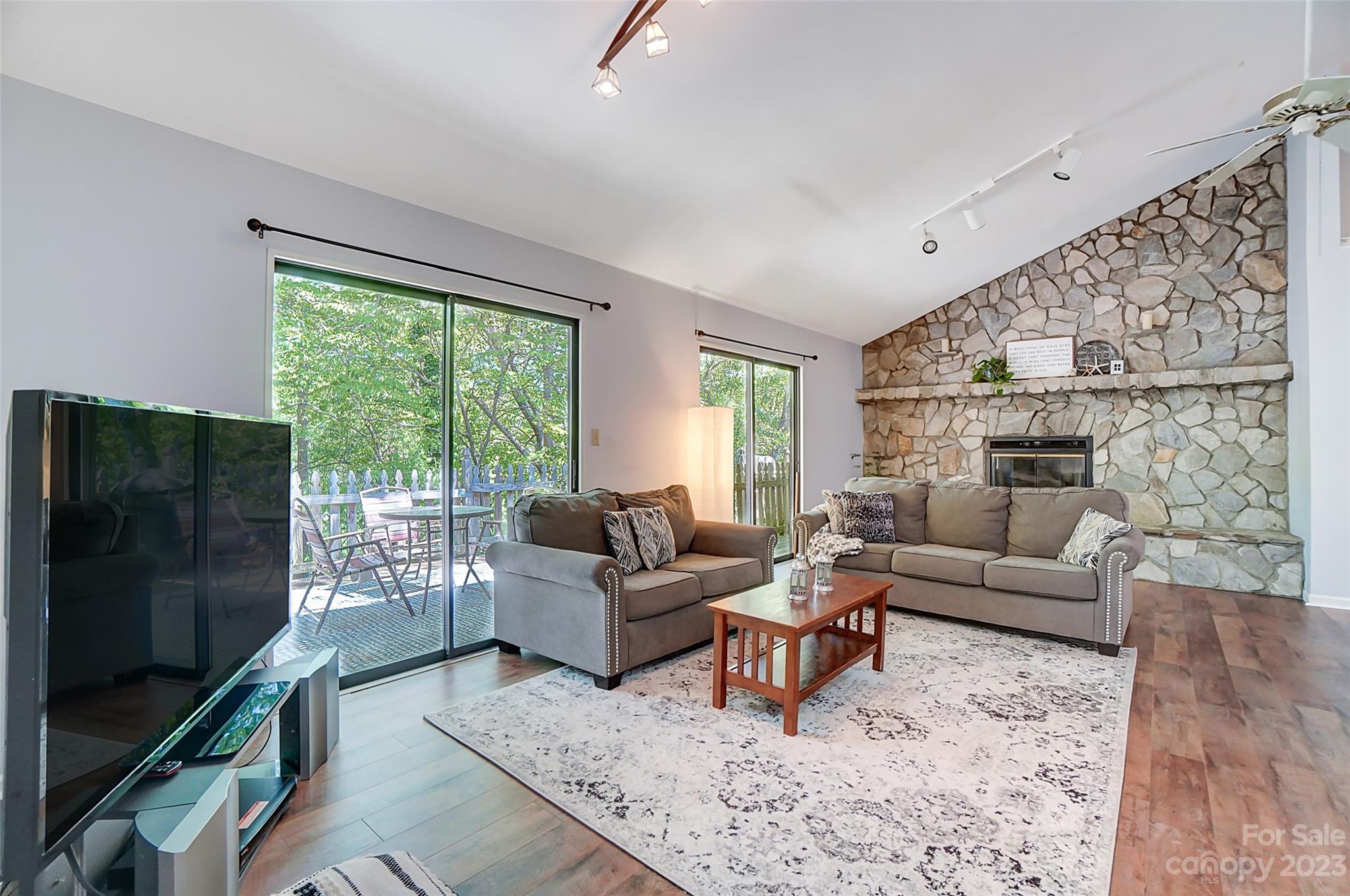 1205 Molokai Drive Tega Cay, SC 29708 - Photo 7 of 32 a living room with furniture tv and a floor to ceiling window