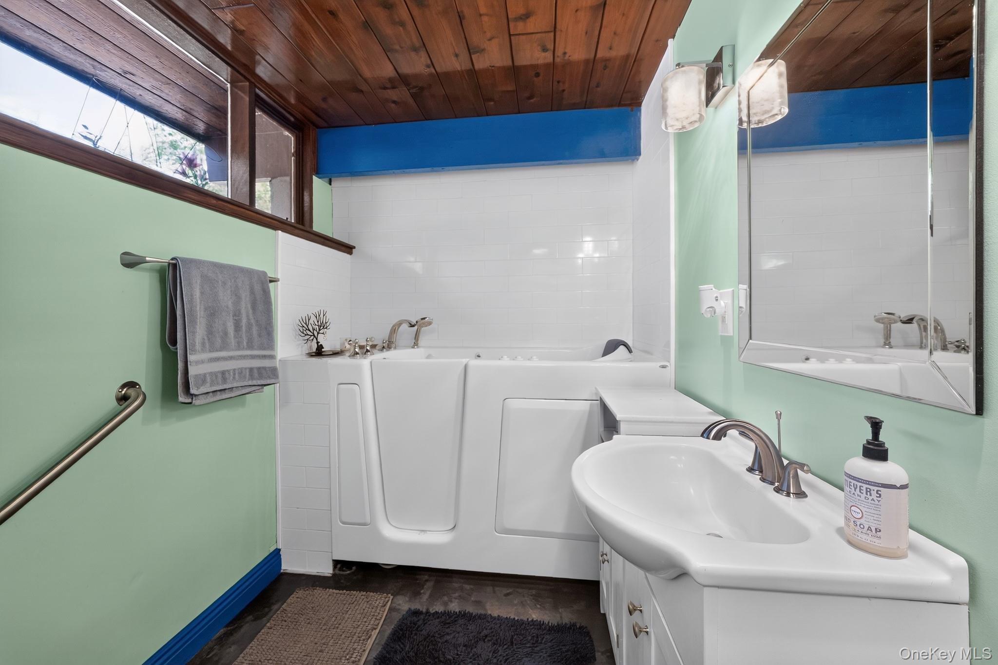 424 Laroe Road Chester, NY 10918 - Photo 6 of 43 Bathroom featuring a walk-in tub with chrome fixtures, a wood-finish ceiling, and a single vanity with an integrated sink and brushed nickel faucet
