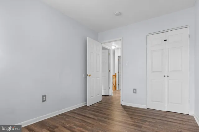 a view of an empty room and wooden floor