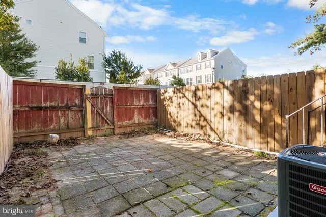 a backyard of a house with lots of green space and wooden fence