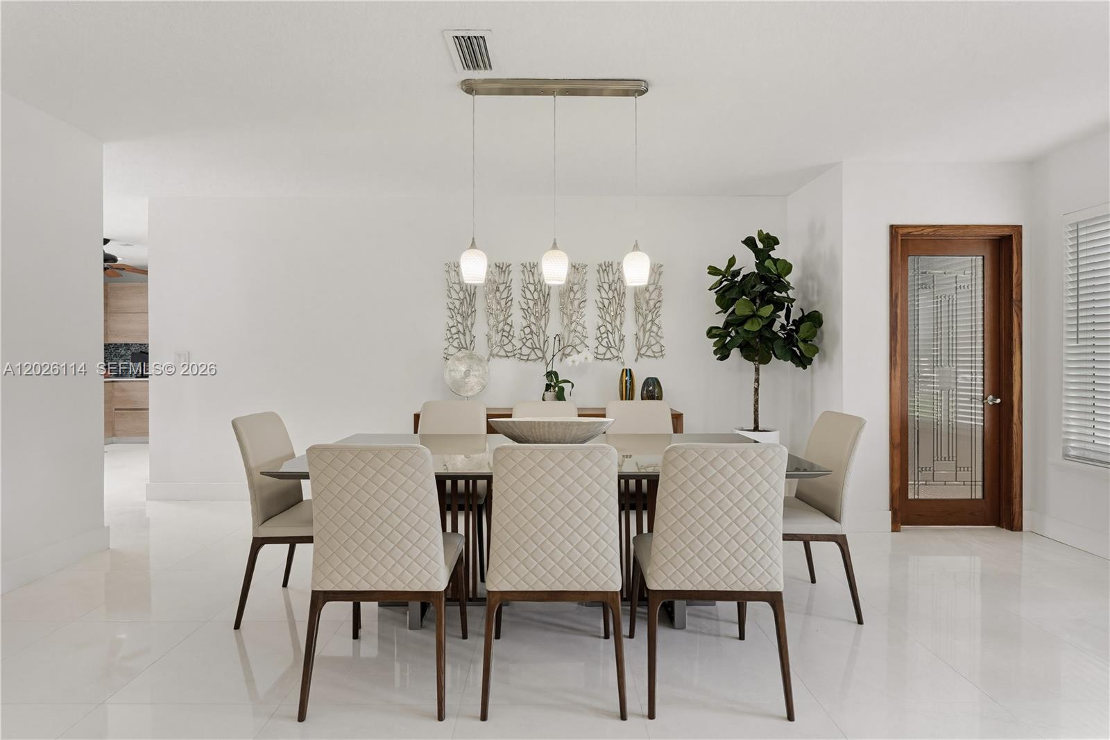 9641 Southwest 66th Street Miami, FL 33173 - Photo 12 of 57 a view of a dining room with furniture and chandelier