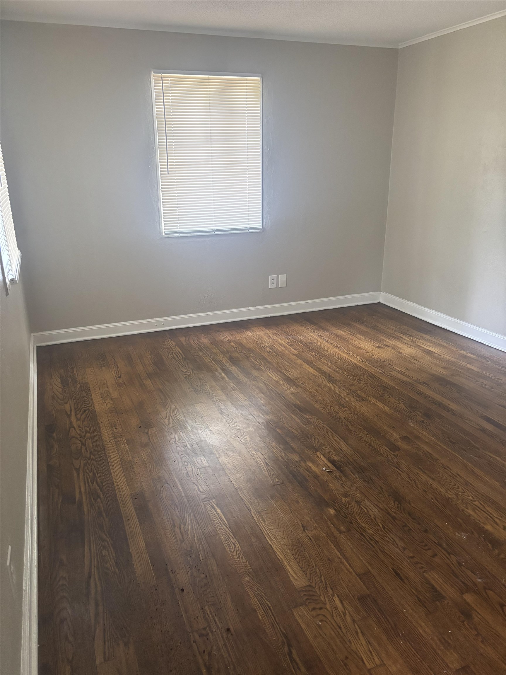 2106 Brookline Road Memphis, TN 38128 - Photo 3 of 10 Unfurnished room with dark wood-type flooring, baseboards, and crown molding