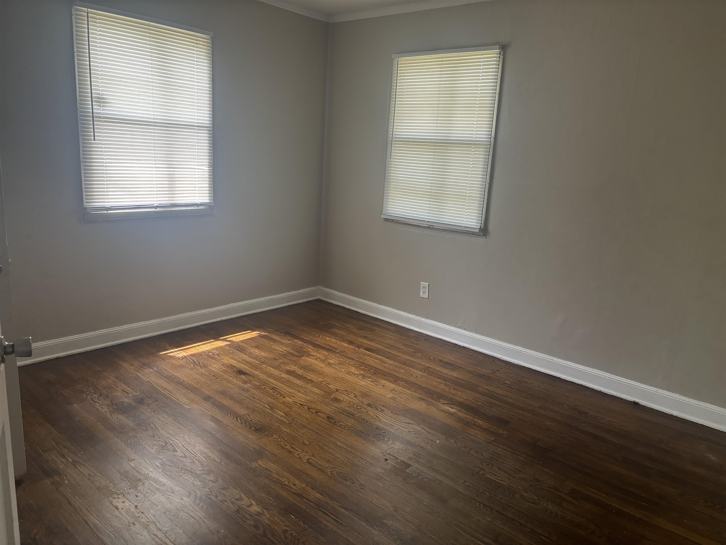 2106 Brookline Road Memphis, TN 38128 - Photo 8 of 10 Spare room featuring baseboards, dark wood-type flooring, and crown molding