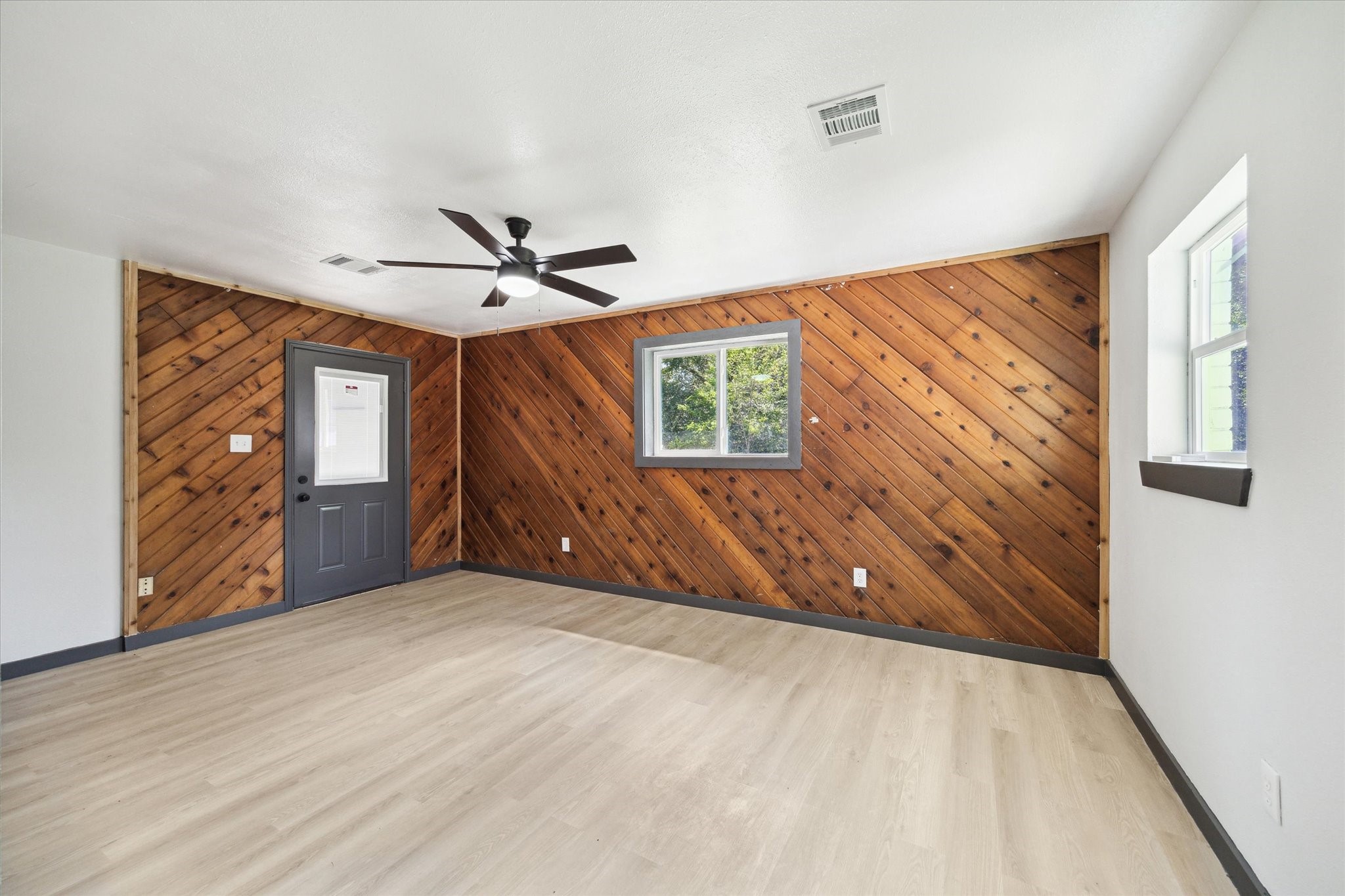 13812 Goodyear Road Dayton, TX 77535 - Photo 11 of 14 wooden floor in an empty room with a window