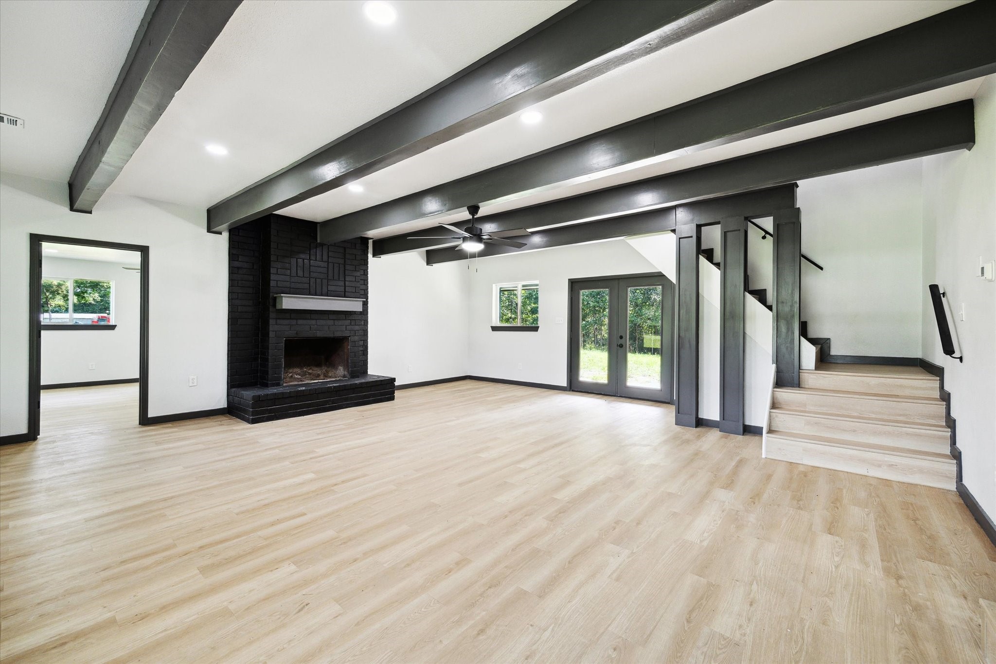 13812 Goodyear Road Dayton, TX 77535 - Photo 4 of 14 a view of an empty room with a fireplace and a window
