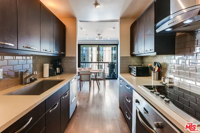 a kitchen with granite countertop lots of counter top space a sink and appliances