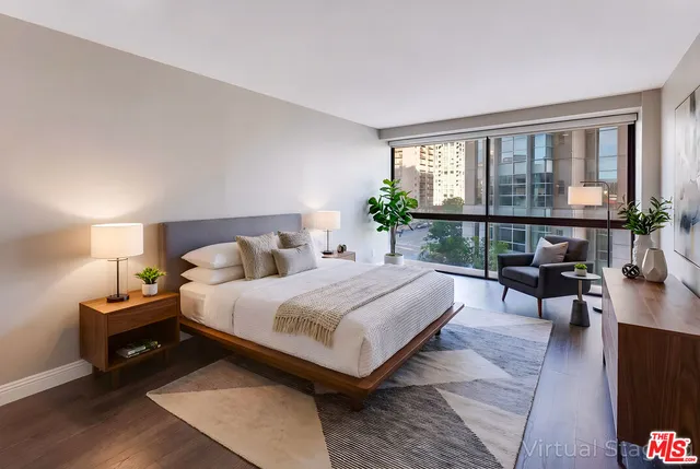 a bedroom with a bed a lamp and window