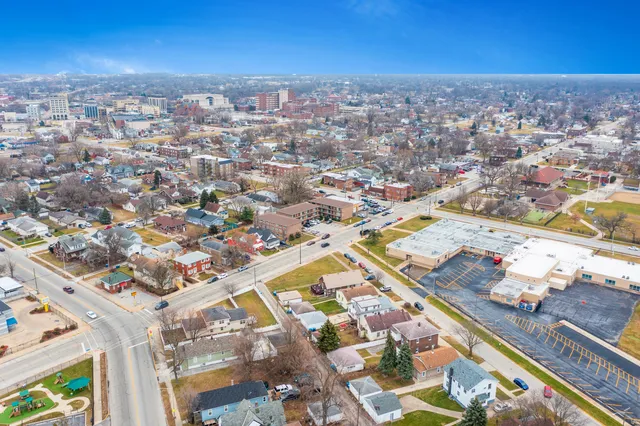 a kitchen with a refrigerator sink and wooden floor