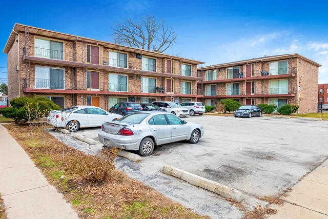 a front view of a residential apartment building with a yard