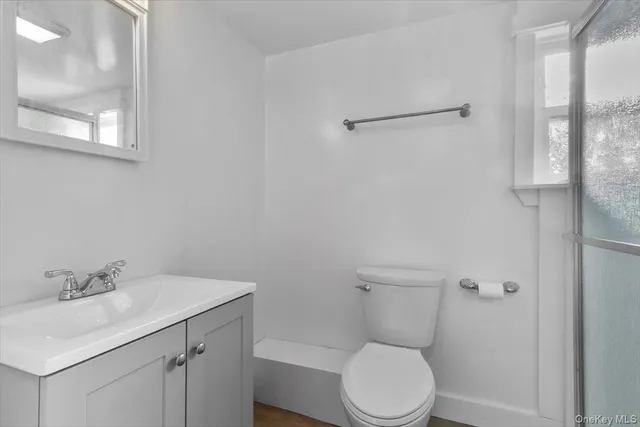 a white toilet sitting next to a bathroom sink