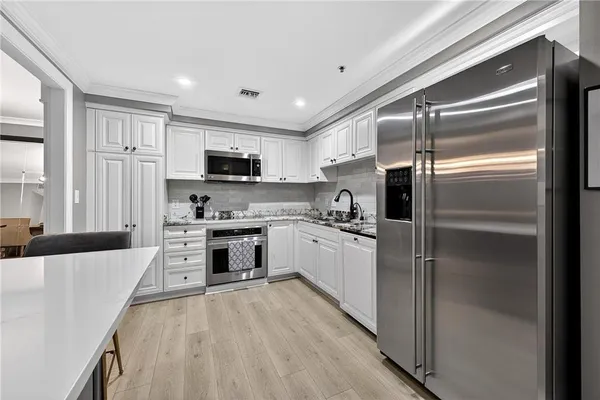 a kitchen with a refrigerator a stove top oven a sink and dishwasher
