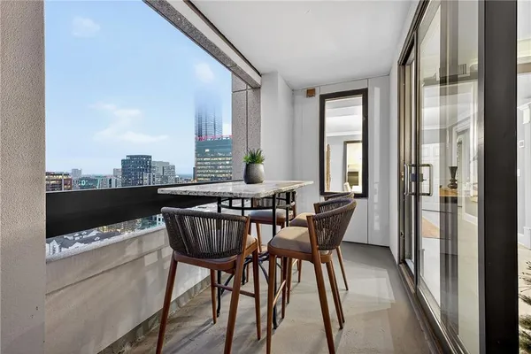 a view of a dining room with furniture window and wooden floor