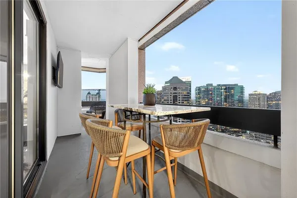 a dining room with furniture and a floor to ceiling window