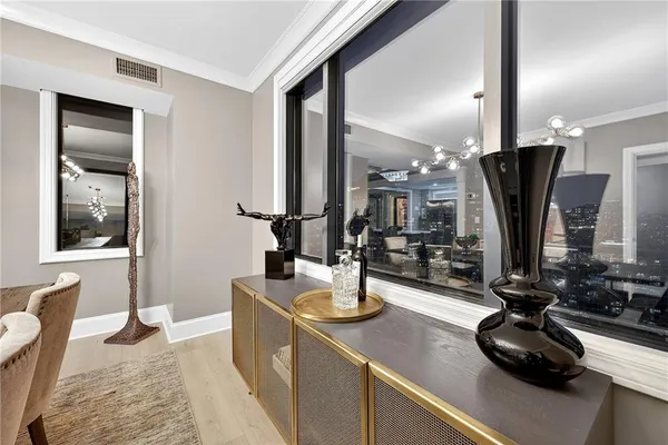 a view of a kitchen with kitchen island granite countertop a sink appliances and cabinets