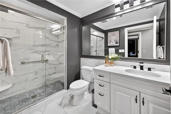 a bathroom with a double vanity sink toilet and shower