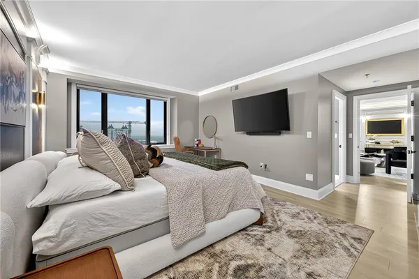 a bedroom with a bed and a flat screen tv