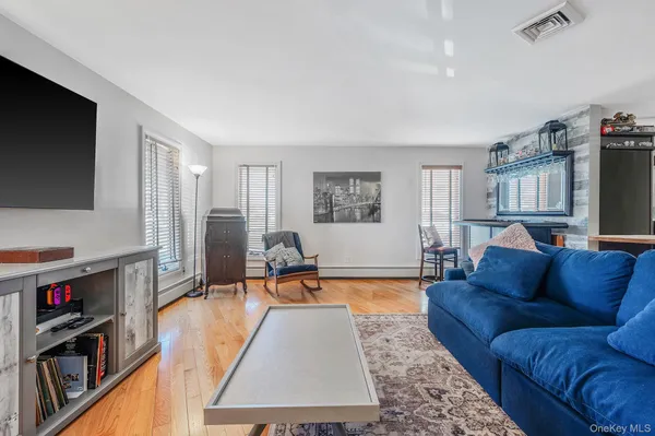 a living room with a couch and a dining table with kitchen view