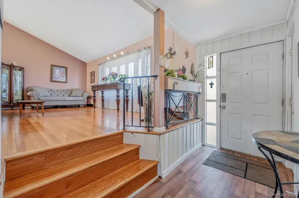 a view of entryway and hall with wooden floor