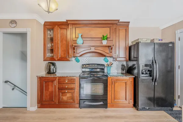 a kitchen with stainless steel appliances granite countertop a refrigerator and a stove