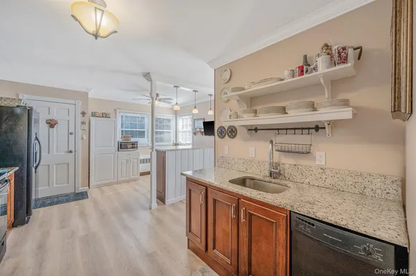 a kitchen with stainless steel appliances granite countertop a sink and refrigerator