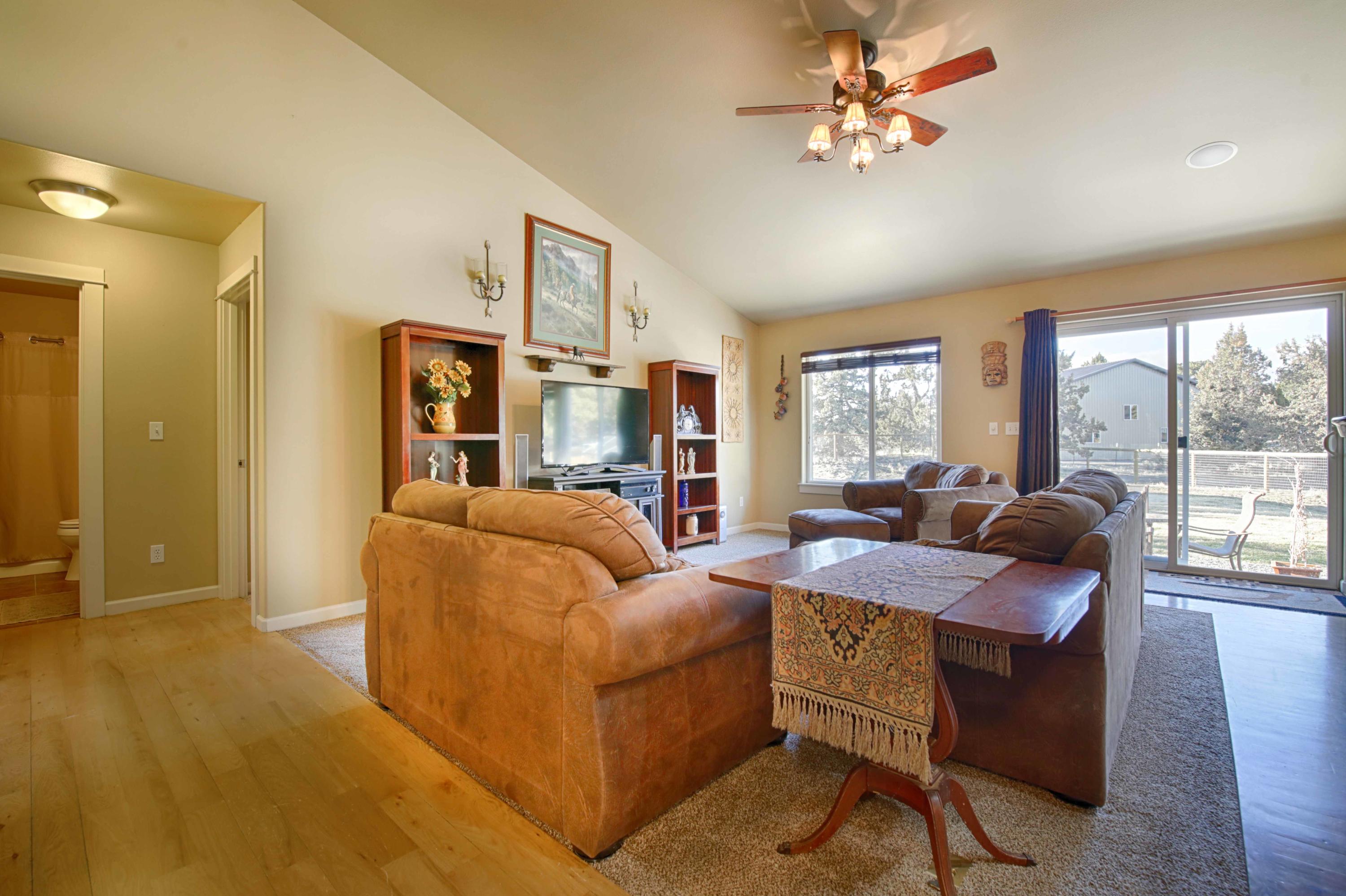 64818 Grande Loop Bend, OR 97701 - Photo 4 of 29 Living room with vaulted ceilings, ceiling fan, slider to back yard.