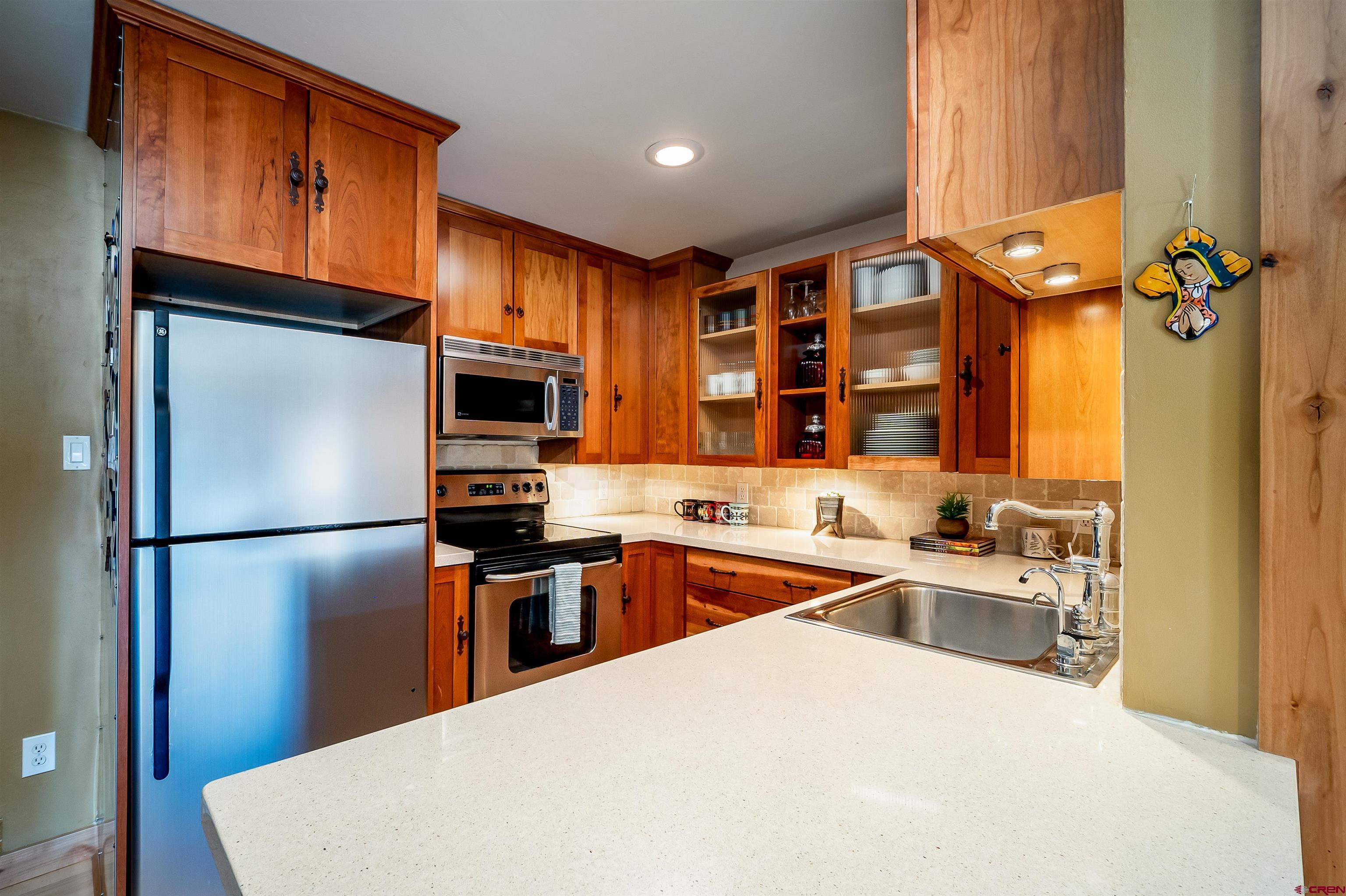 455 Sheol Street, Unit 320 Durango, CO 81301 - Photo 3 of 42 a kitchen with stainless steel appliances a refrigerator sink and stove