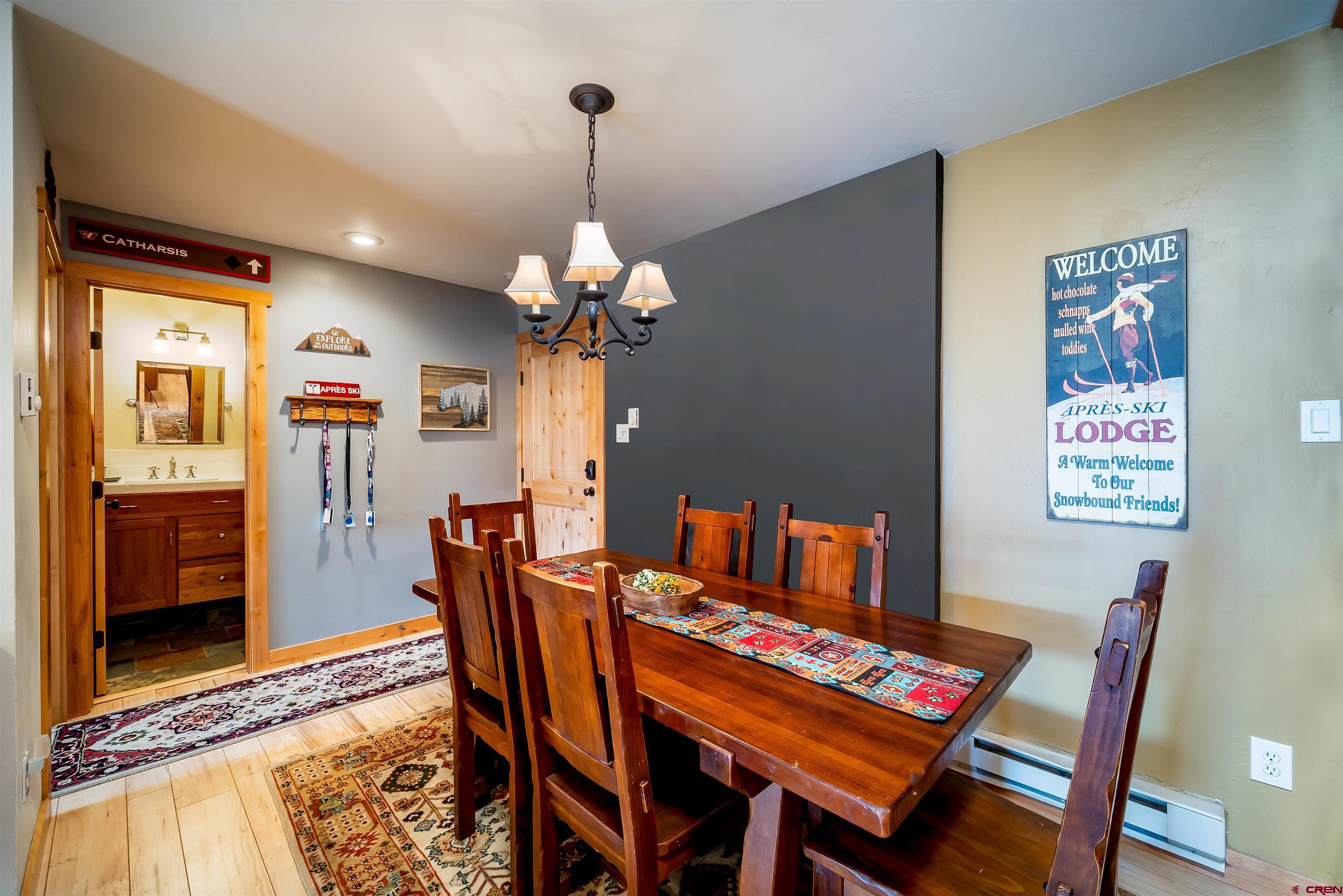 455 Sheol Street, Unit 320 Durango, CO 81301 - Photo 8 of 42 a dining room with furniture a rug and a chandelier