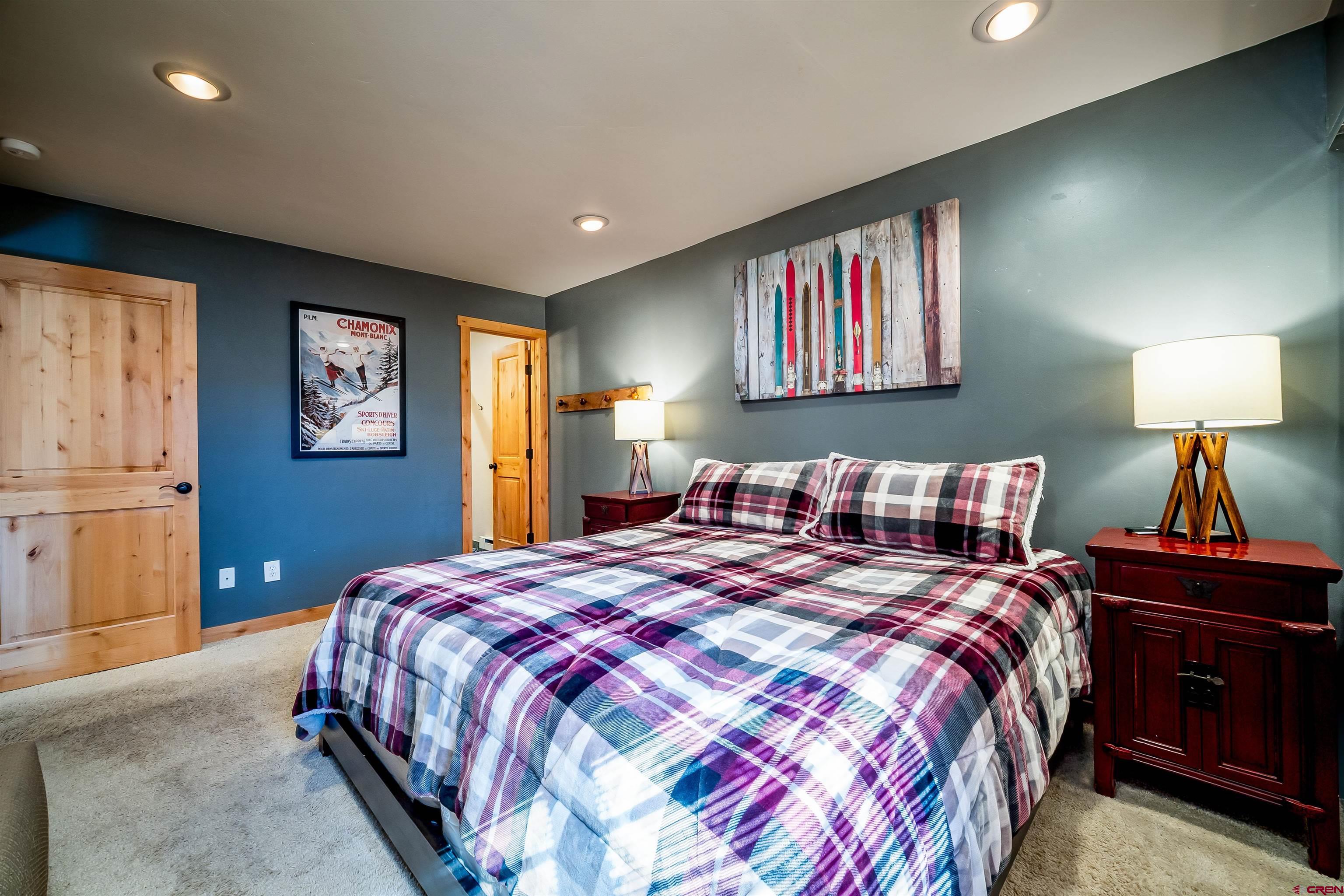 455 Sheol Street, Unit 320 Durango, CO 81301 - Photo 10 of 42 a bedroom with double bed and a chandelier