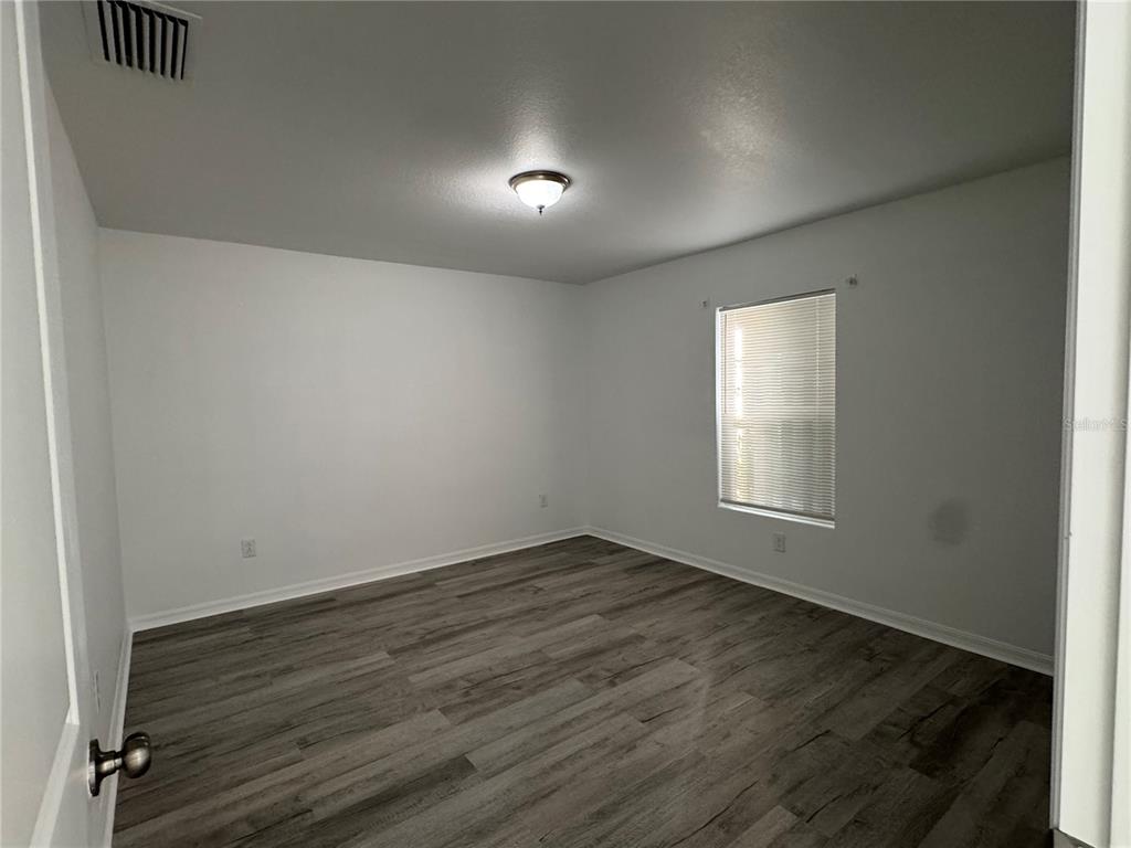 2173 Halblum Street North Port, FL 34288 - Photo 13 of 18 an empty room with wooden floor and windows