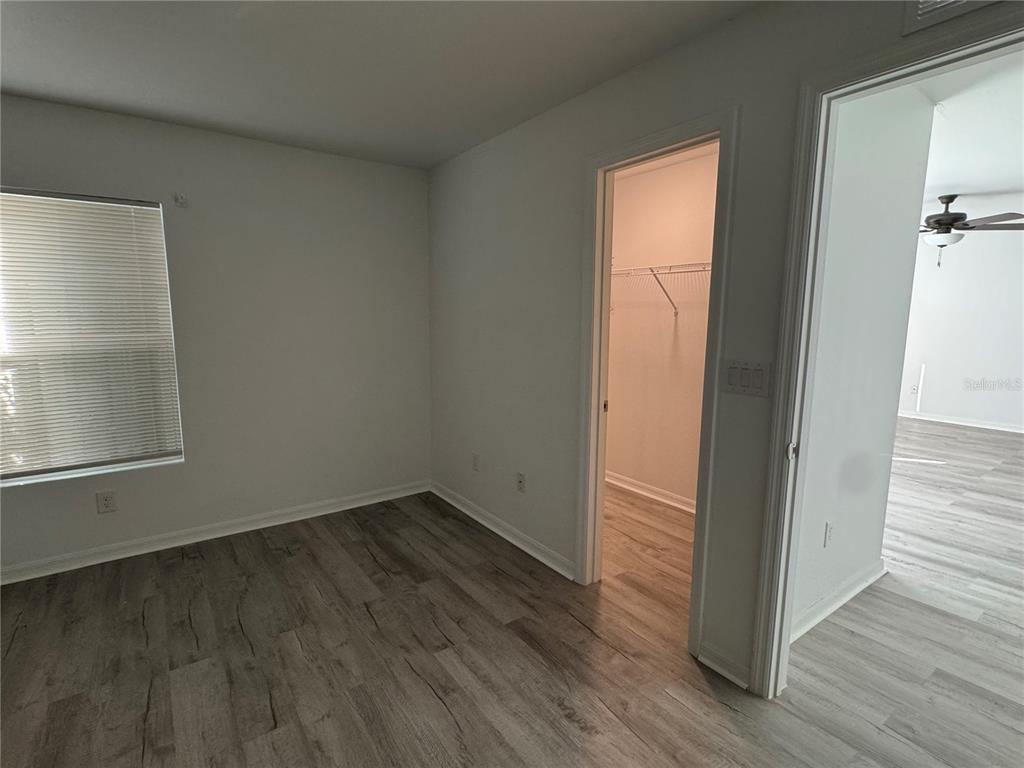 2173 Halblum Street North Port, FL 34288 - Photo 14 of 18 an empty room with wooden floor and windows