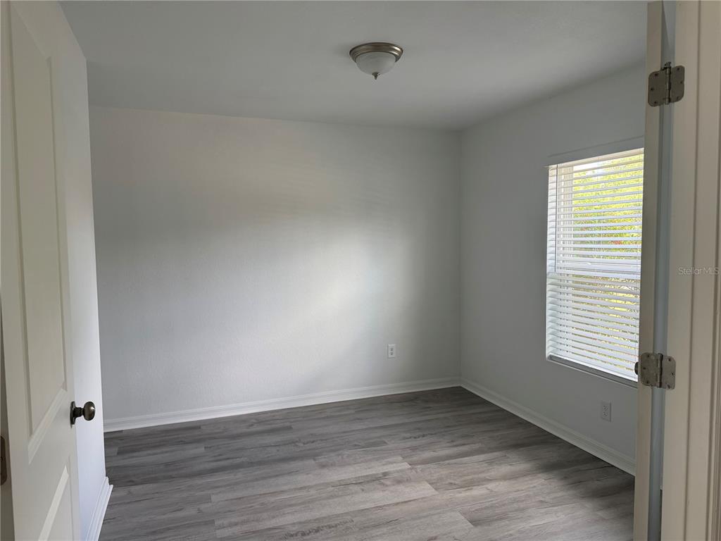 2173 Halblum Street North Port, FL 34288 - Photo 2 of 18 an empty room with wooden floor and windows