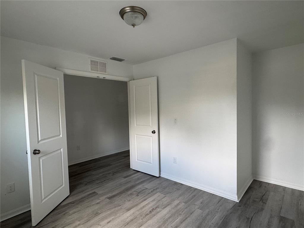 2173 Halblum Street North Port, FL 34288 - Photo 3 of 18 an empty room with wooden floor and windows