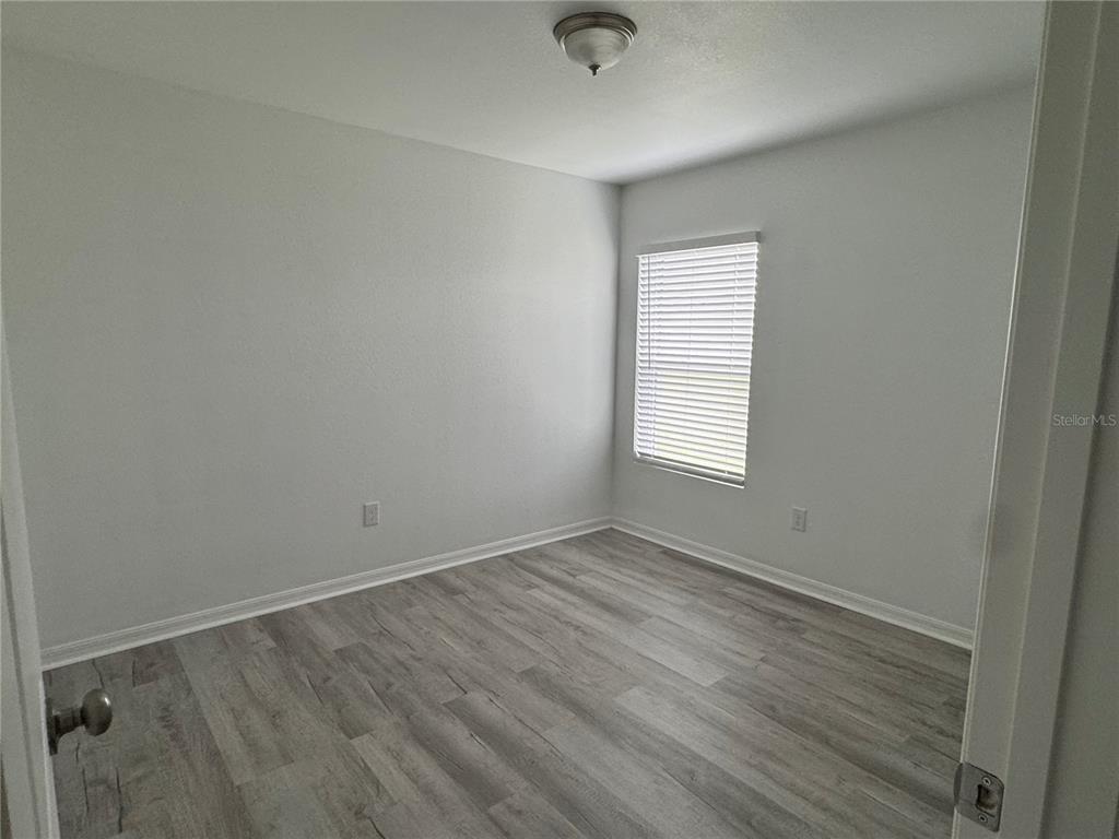 2173 Halblum Street North Port, FL 34288 - Photo 5 of 18 an empty room with wooden floor and windows