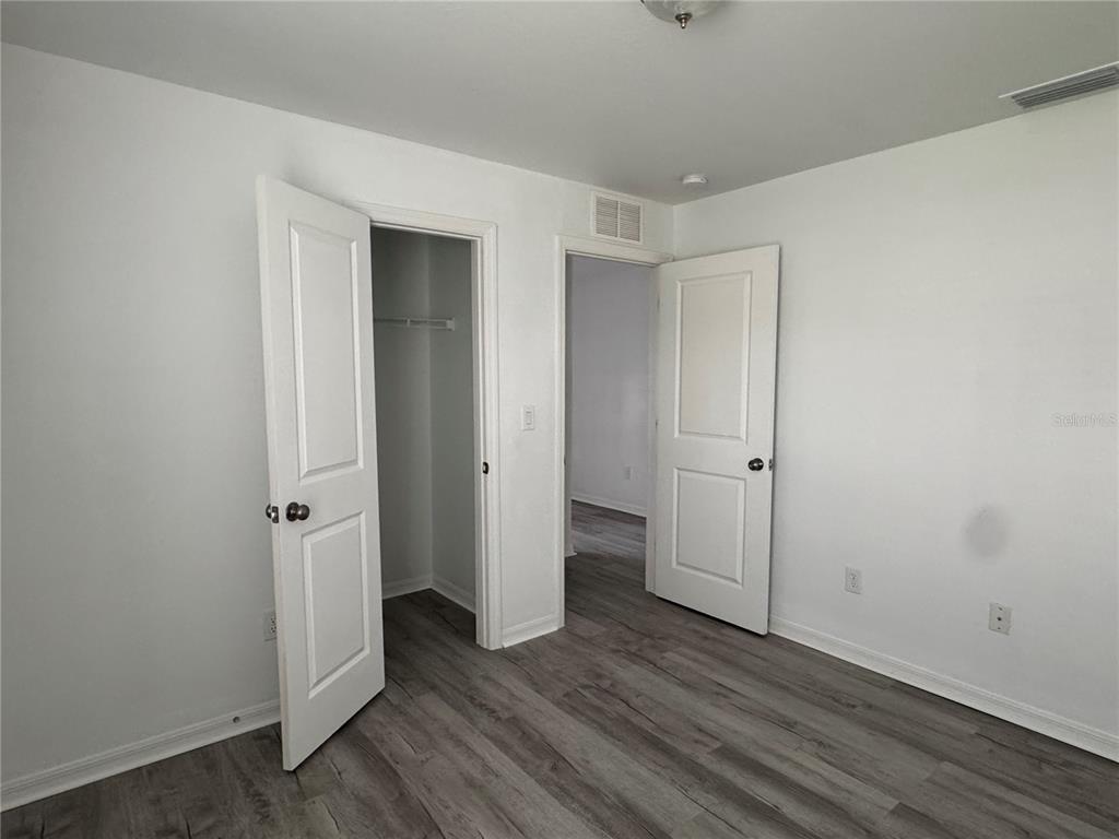 2173 Halblum Street North Port, FL 34288 - Photo 6 of 18 a view of an empty room with wooden floor