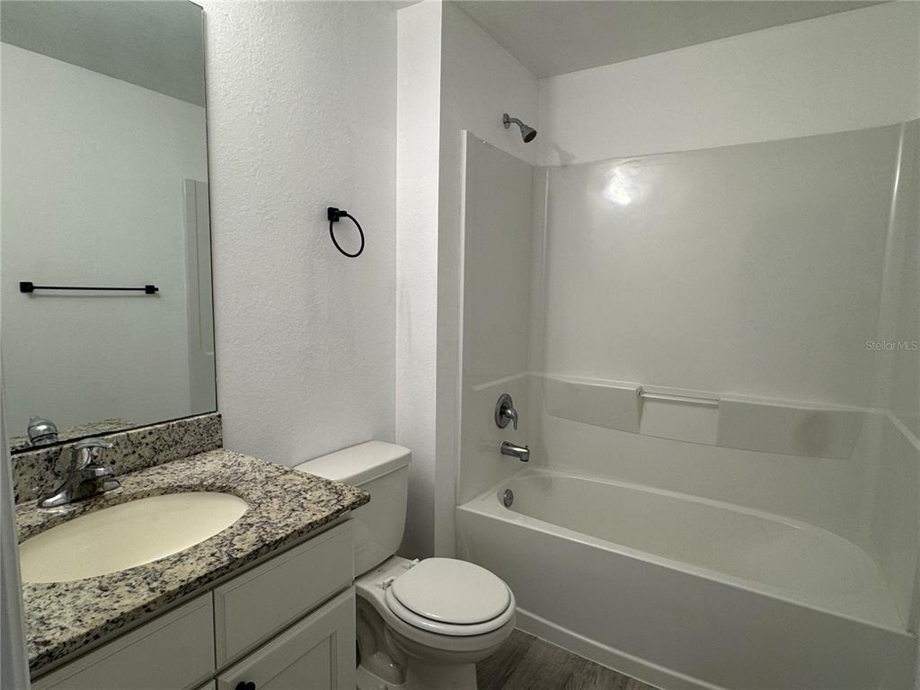 2173 Halblum Street North Port, FL 34288 - Photo 7 of 18 a bathroom with a granite countertop sink a toilet and shower