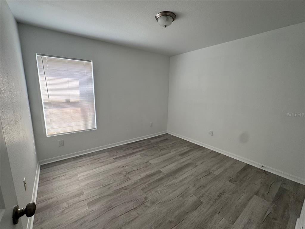 2173 Halblum Street North Port, FL 34288 - Photo 9 of 18 an empty room with wooden floor and windows