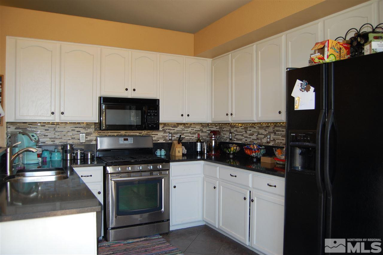 1378 Backer Way Reno, NV 89523 - Photo 6 of 25 a kitchen with white cabinets and appliances