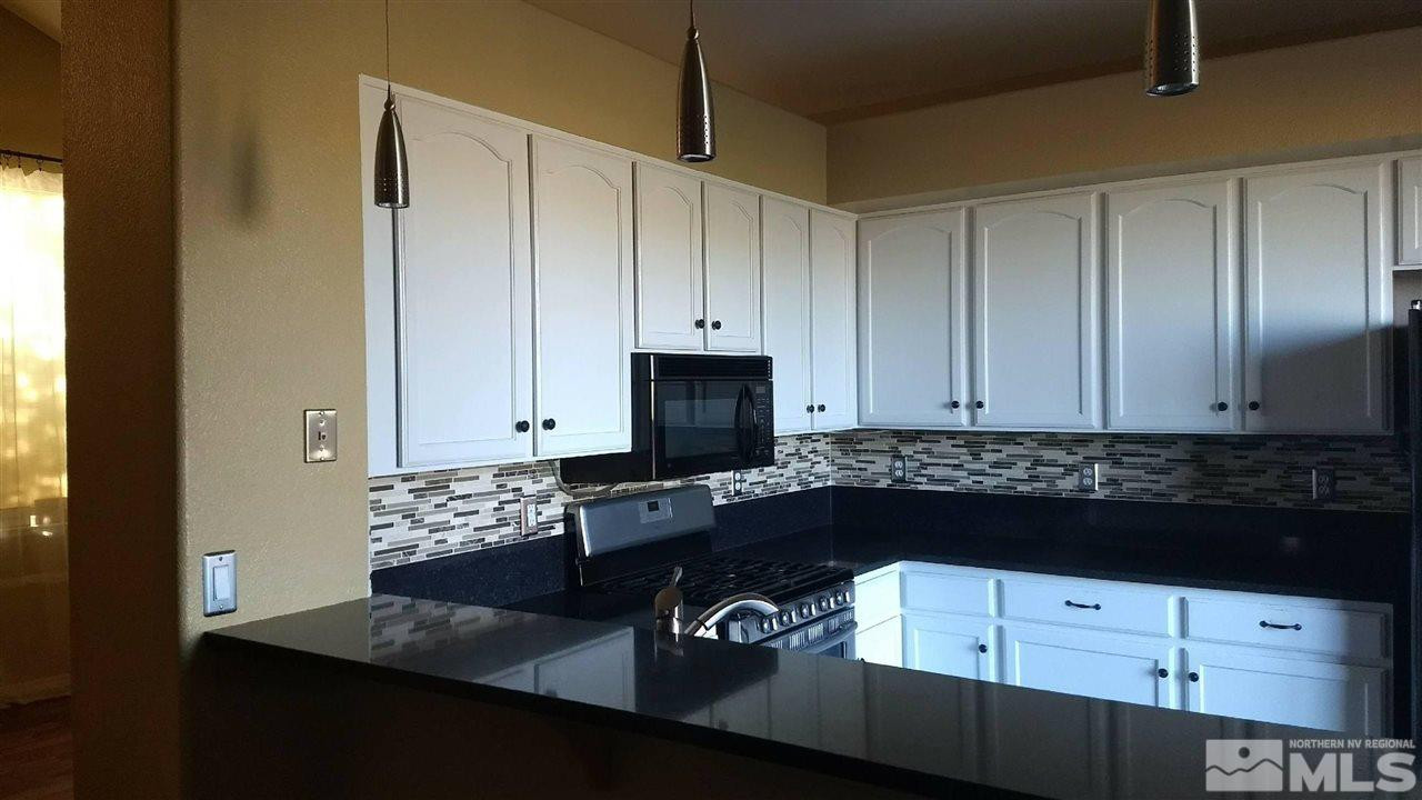 1378 Backer Way Reno, NV 89523 - Photo 8 of 25 a kitchen with a refrigerator and cabinets