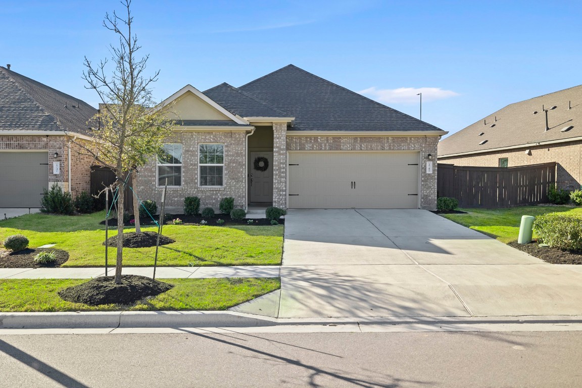 1745 Woolsey Way Leander, TX 78641 - Photo 1 of 1 a view of a house with a yard and plants