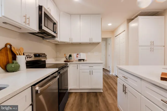 a kitchen with a sink a stove and cabinets