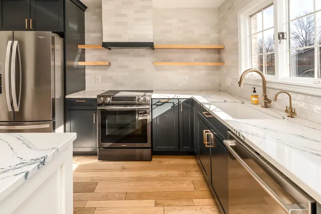 a kitchen with a sink cabinets and stainless steel appliances