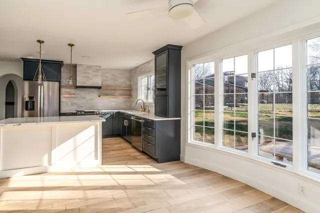 a kitchen with stainless steel appliances granite countertop a stove a sink and a refrigerator
