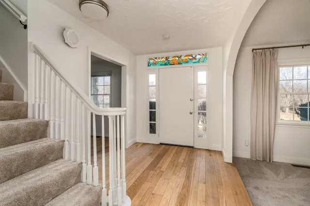 a view of a livingroom with furniture and staircase